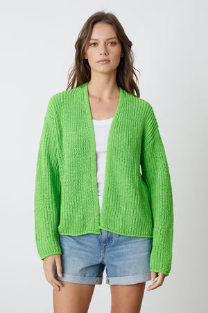 A model wearing a Velvet by Graham & Spencer TERRAH OPEN FRONT CARDIGAN in bright glow green