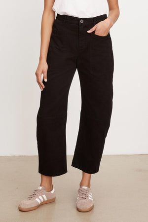 A woman wearing Velvet by Graham & Spencer's BRYLIE SANDED TWILL UTILITY PANT with patch pockets and a white t-shirt.