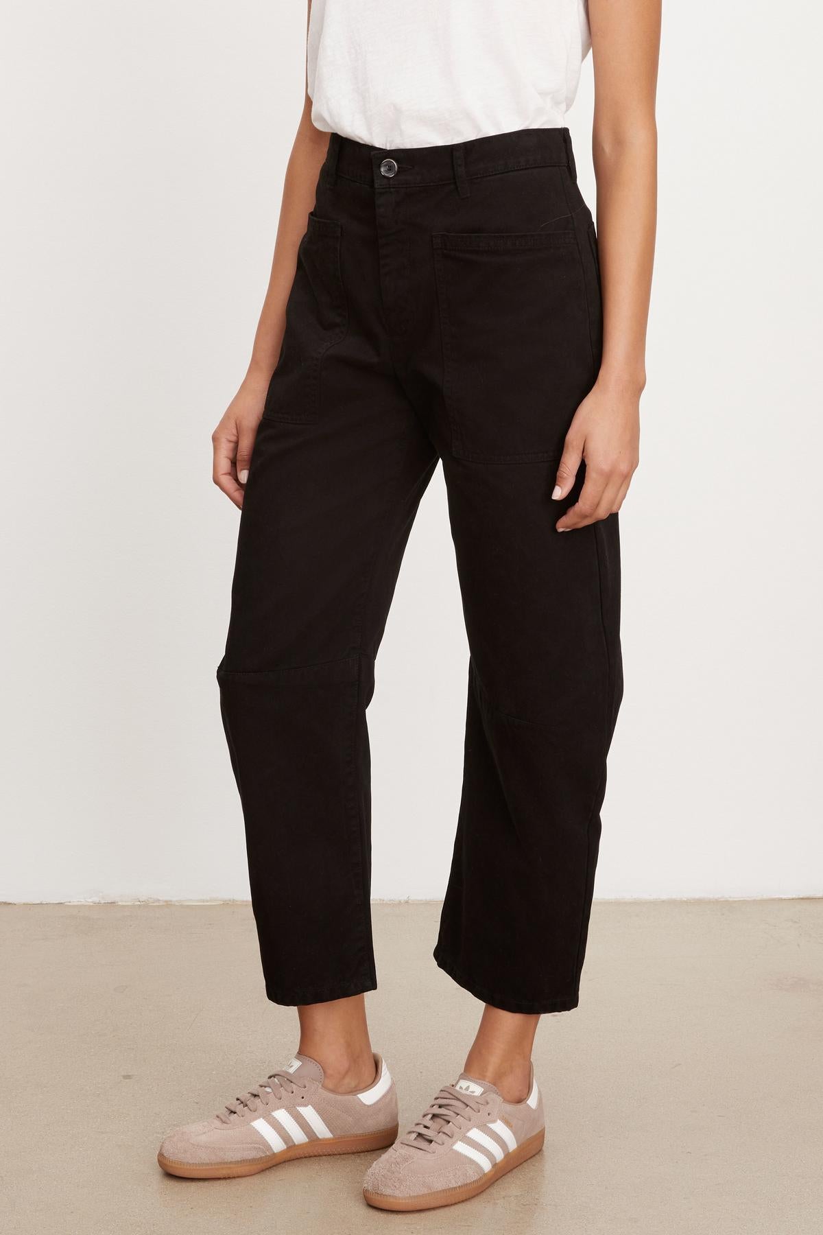 A woman wearing Velvet by Graham & Spencer's BRYLIE SANDED TWILL UTILITY PANT cropped pants and a white t-shirt.-35955673727169