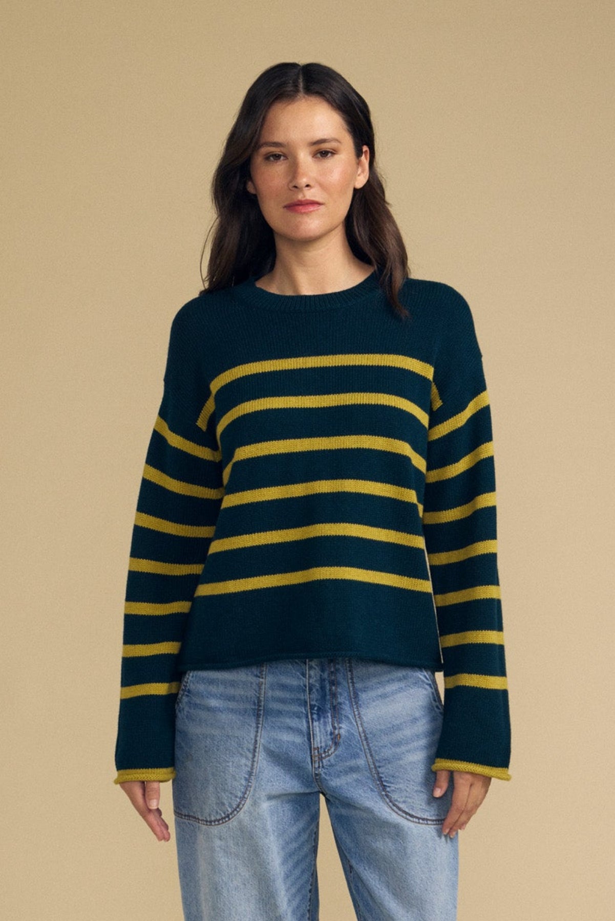 Front view of LUCIA dark green cotton cashmere striped crew neck sweater on a model, relaxed fit against beige background
