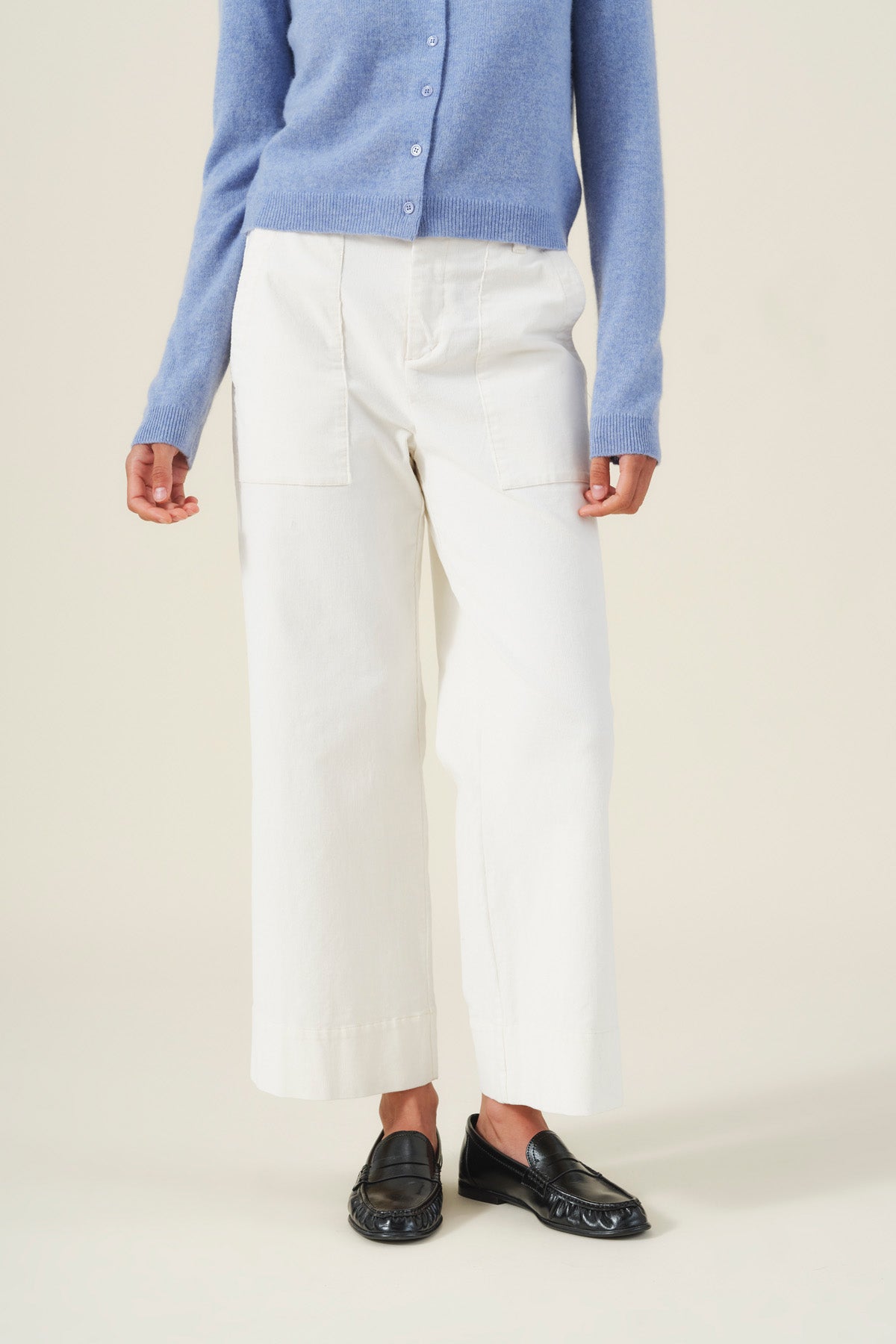 Person wearing a light blue button-down sweater and off-white VERA CORDUROY PANT high-rise wide-leg pants with patch pockets, paired with black loafers.