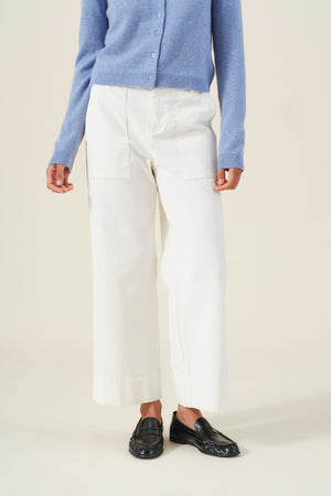 Person wearing a light blue button-down sweater and off-white VERA CORDUROY PANT high-rise wide-leg pants with patch pockets, paired with black loafers.
