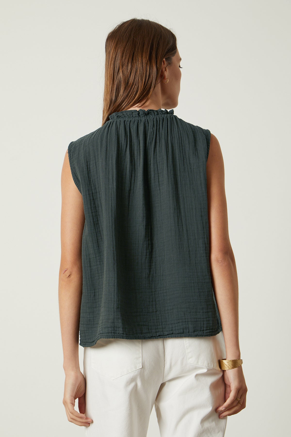   the back view of a woman wearing a Velvet by Graham & Spencer BIANCA COTTON GAUZE TANK TOP and white pants. 