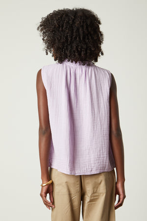 the back view of a woman wearing a Velvet by Graham & Spencer BIANCA COTTON GAUZE TANK TOP and tan pants.