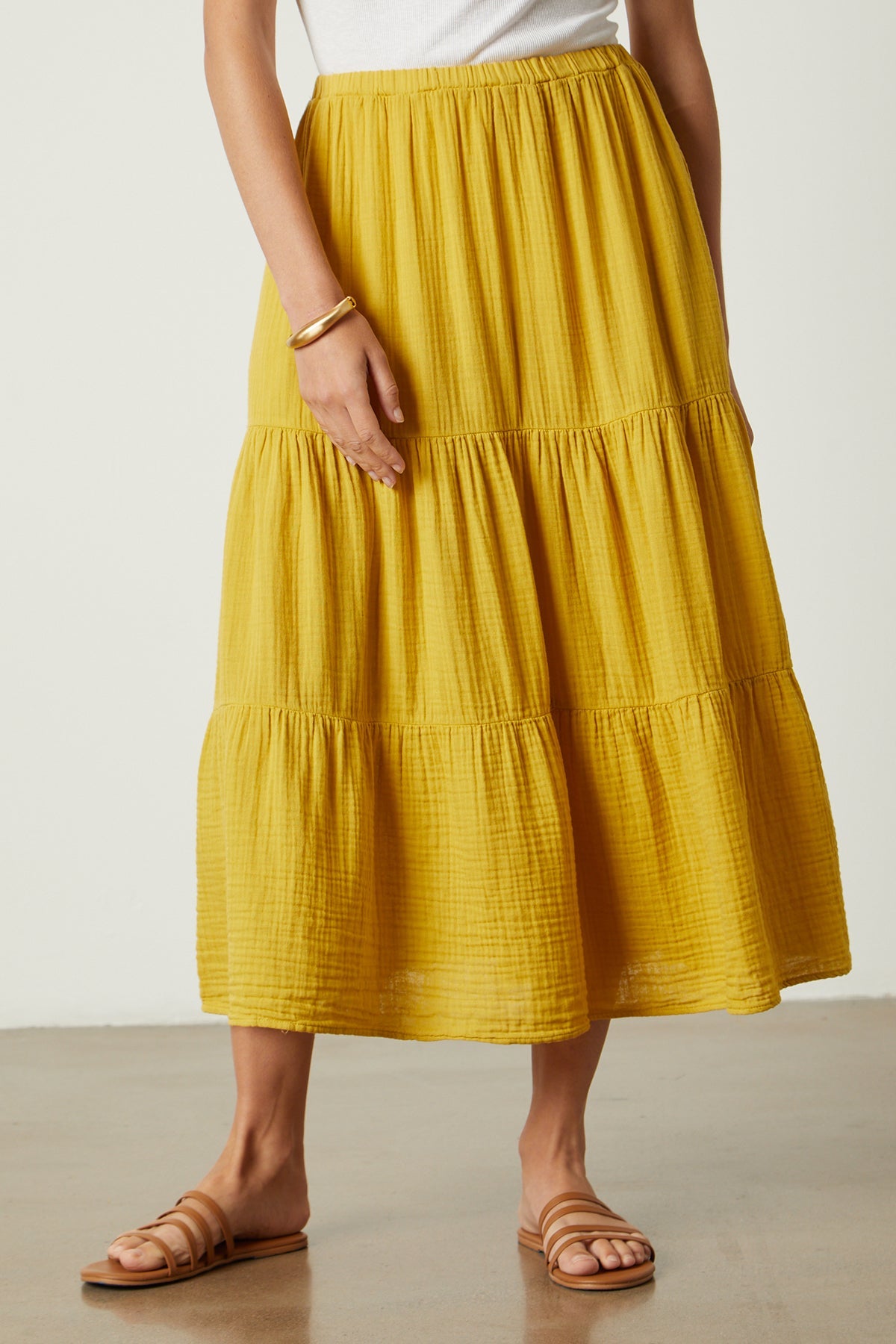 a woman wearing a yellow Velvet by Graham & Spencer Danielle Cotton Gauze Tiered Skirt.-35888321429697
