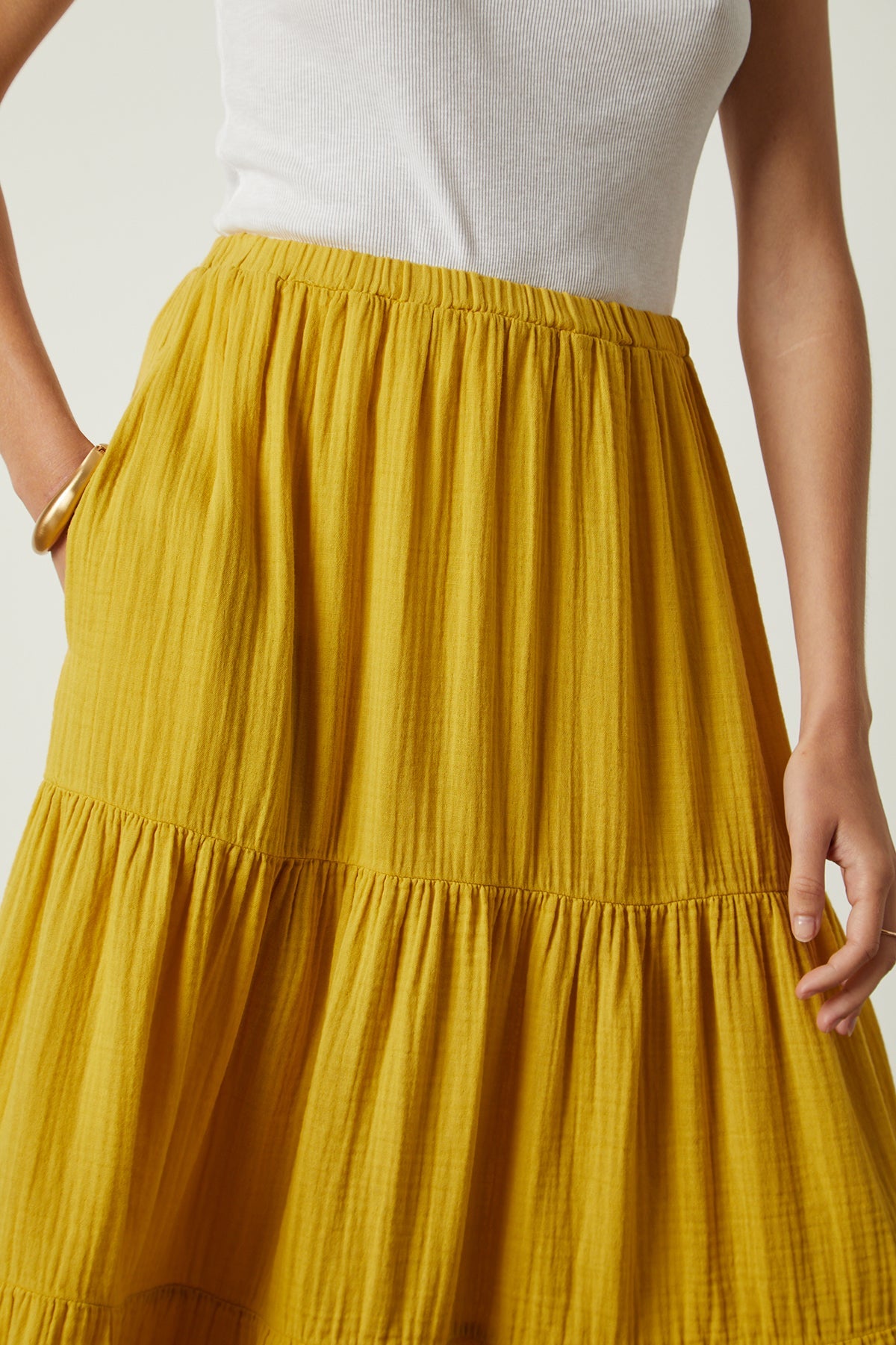   a woman wearing a yellow Velvet by Graham & Spencer Danielle Cotton Gauze Tiered Skirt. 