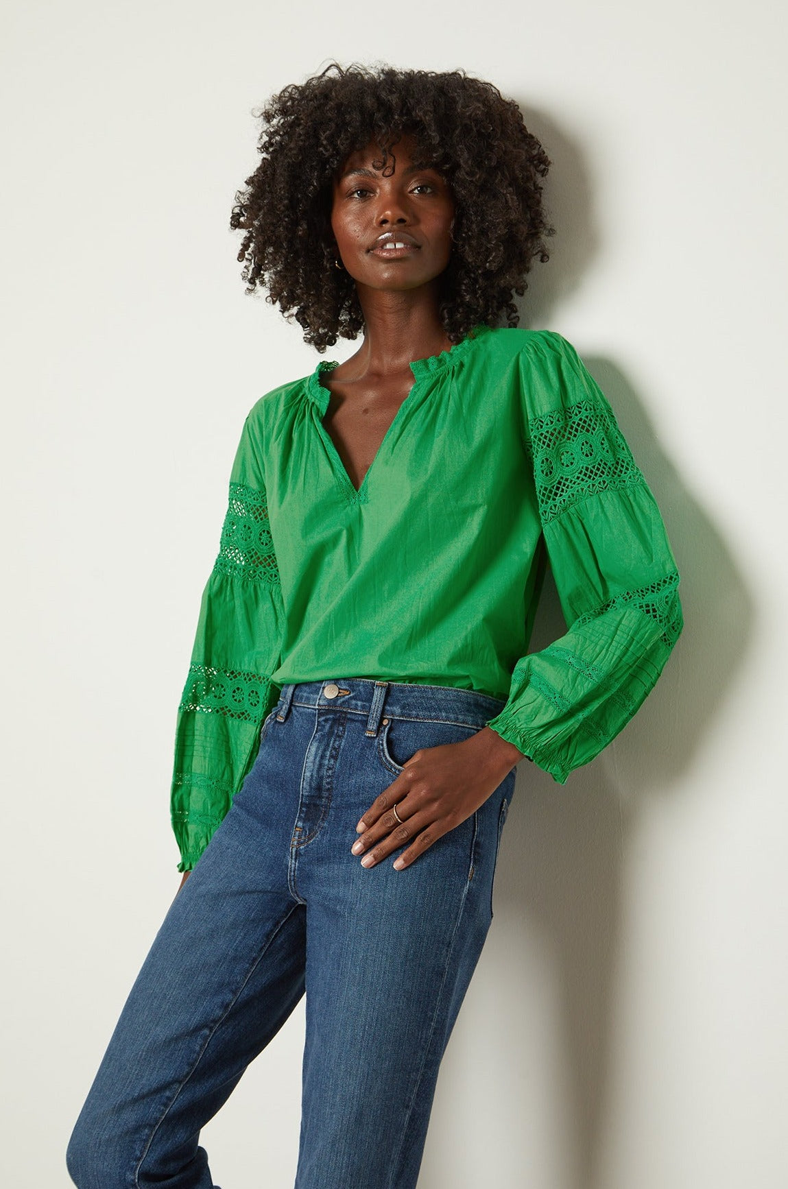   a black woman wearing jeans and a green blouse, the TAYLER COTTON LACE BOHO TOP by Velvet by Graham & Spencer. 