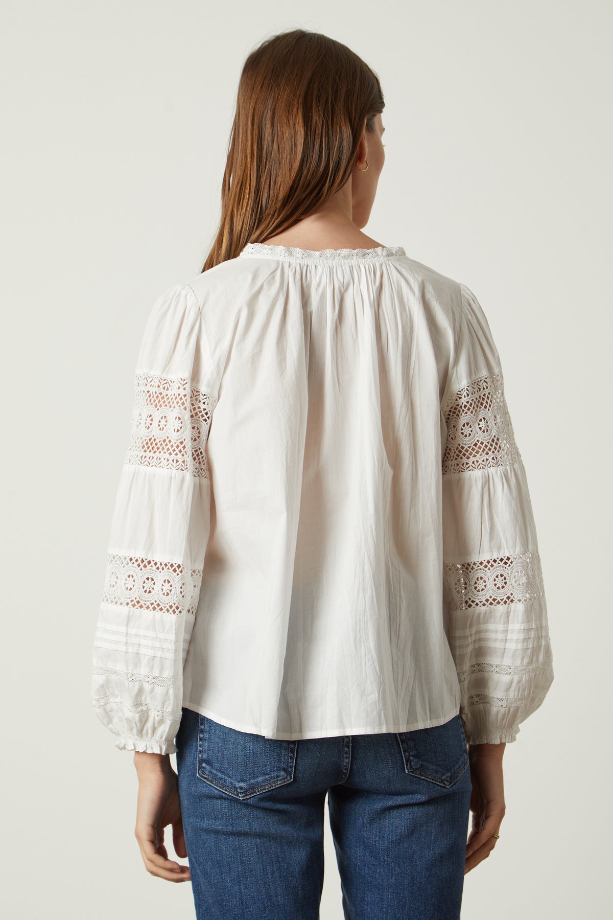 the back view of a woman wearing a Velvet by Graham & Spencer TAYLER COTTON LACE BOHO TOP.-26317098549441