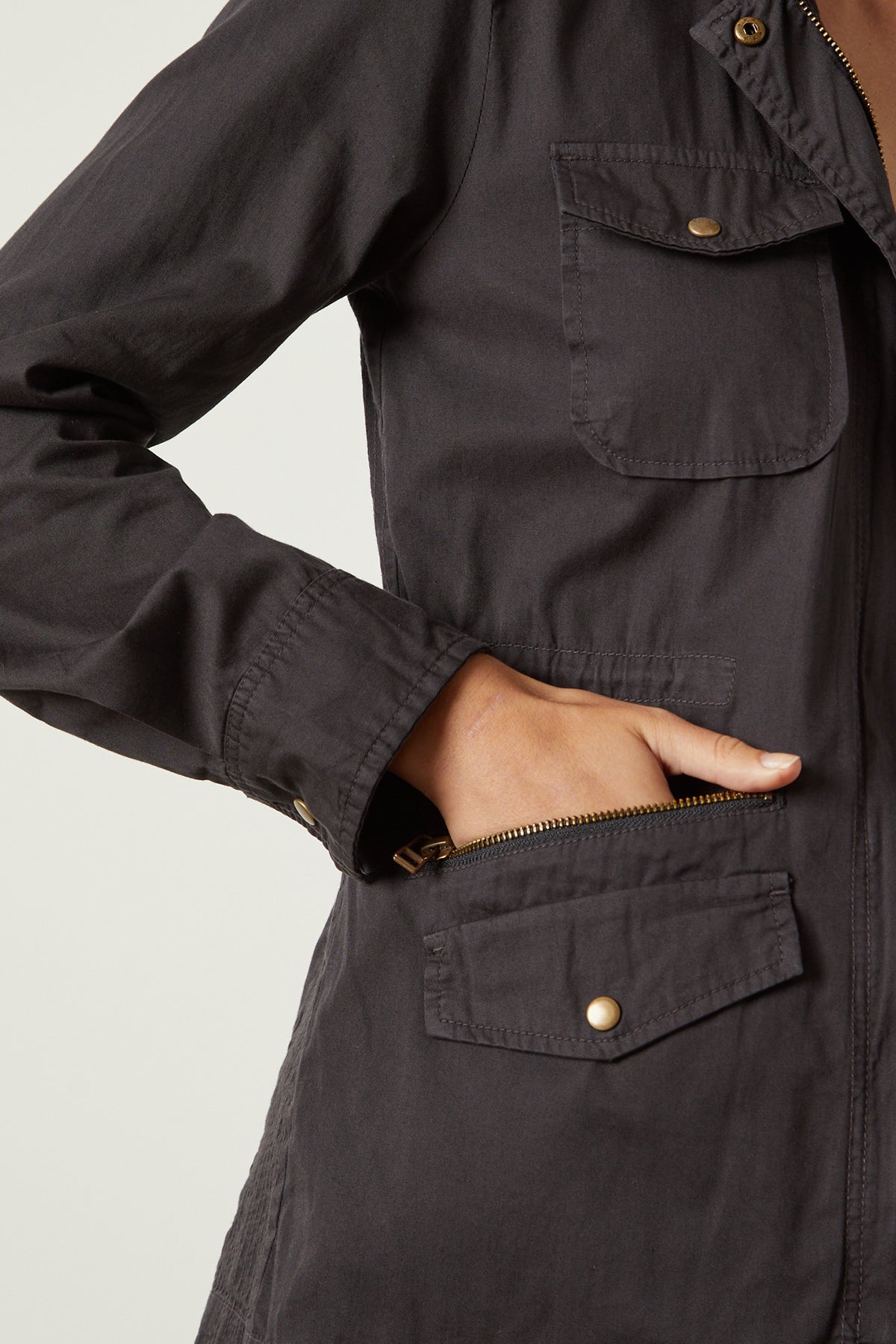   A woman wearing a Velvet by Graham & Spencer RUBY LIGHT-WEIGHT ARMY JACKET with pockets. 