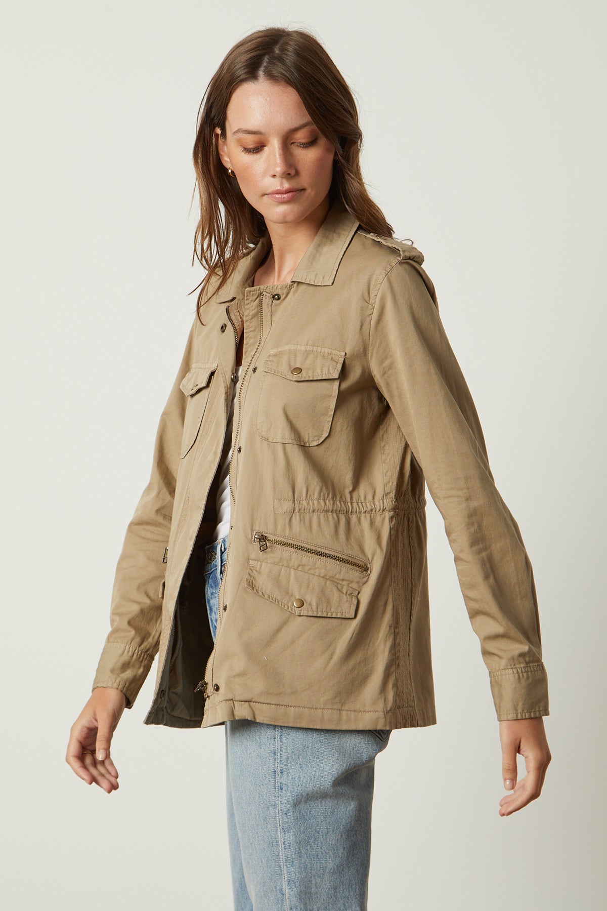 a woman wearing a RUBY LIGHT-WEIGHT ARMY JACKET by Velvet by Graham & Spencer and jeans.-26632088420545