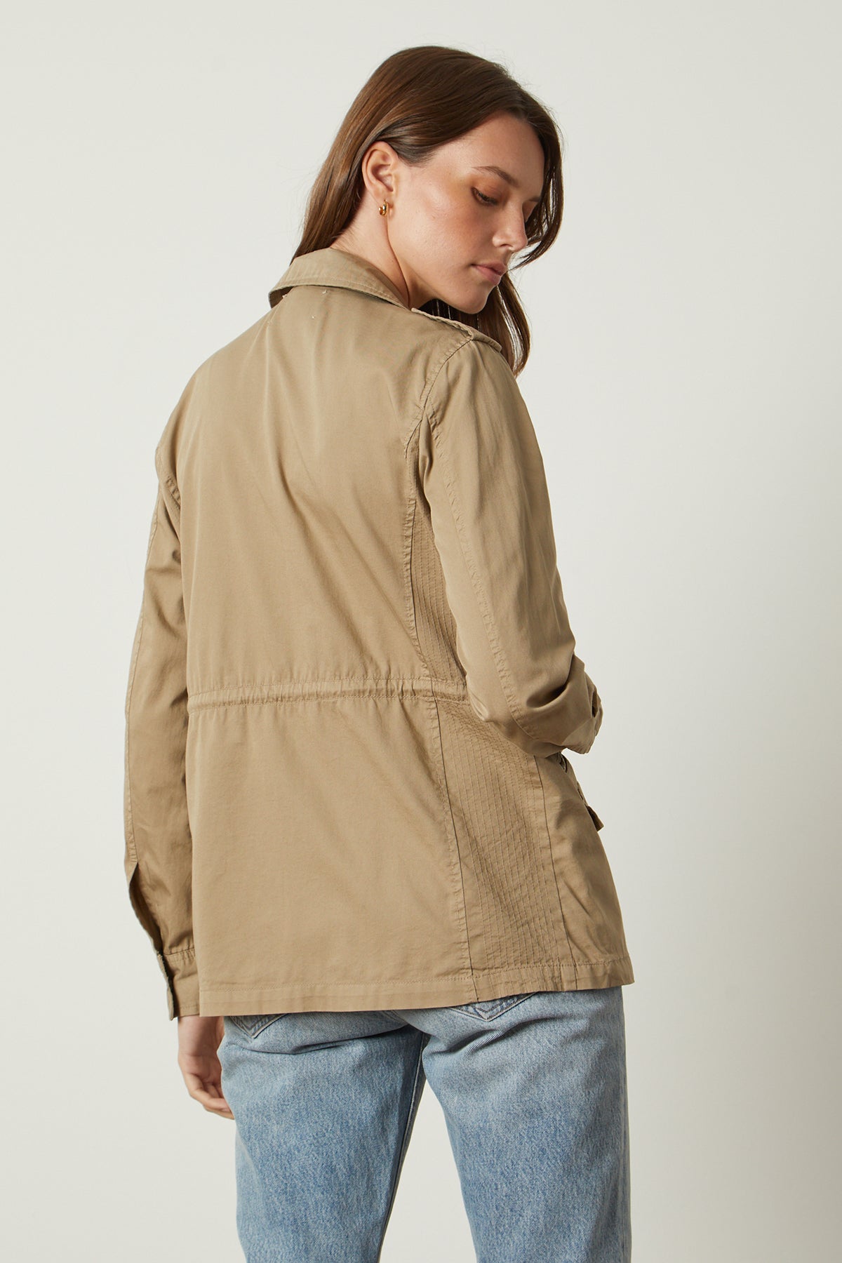 The back view of a woman wearing a Velvet by Graham & Spencer RUBY LIGHT-WEIGHT ARMY JACKET.-26632088551617