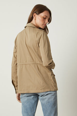 The back view of a woman wearing a Velvet by Graham & Spencer RUBY LIGHT-WEIGHT ARMY JACKET.