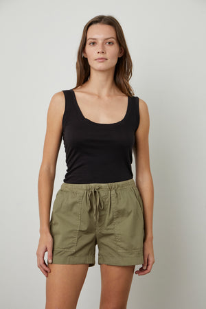 A woman wearing a black tank top and green Velvet by Graham & Spencer TENLEY COTTON TWILL SHORTS.