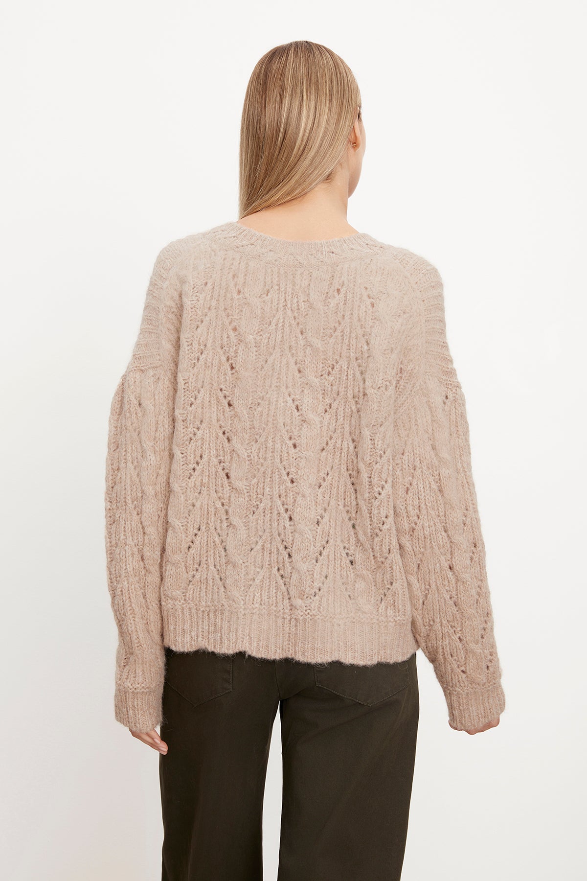   The back view of a woman wearing a Velvet by Graham & Spencer SADE ALPACA BLEND V-NECK SWEATER. 