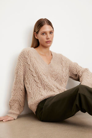 The model is wearing a SADE ALPACA BLEND V-NECK SWEATER from Velvet by Graham & Spencer.