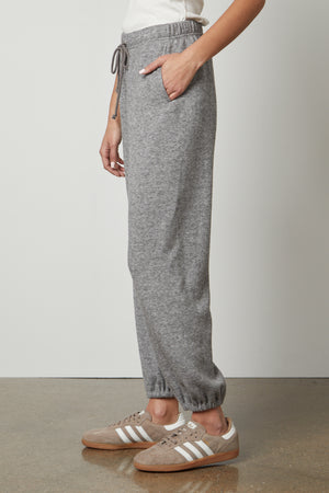 A woman wearing Velvet by Graham & Spencer's Haley Double Knit Sweatpants with an elastic drawstring waist.