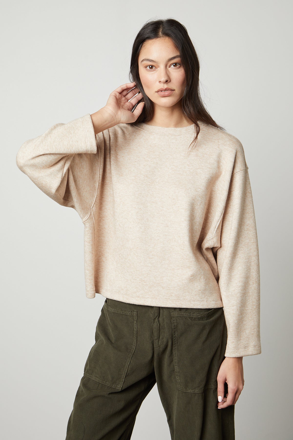   The model is wearing the NIA DOUBLE KNIT CROPPED CREW by Velvet by Graham & Spencer for a comfortable style. 
