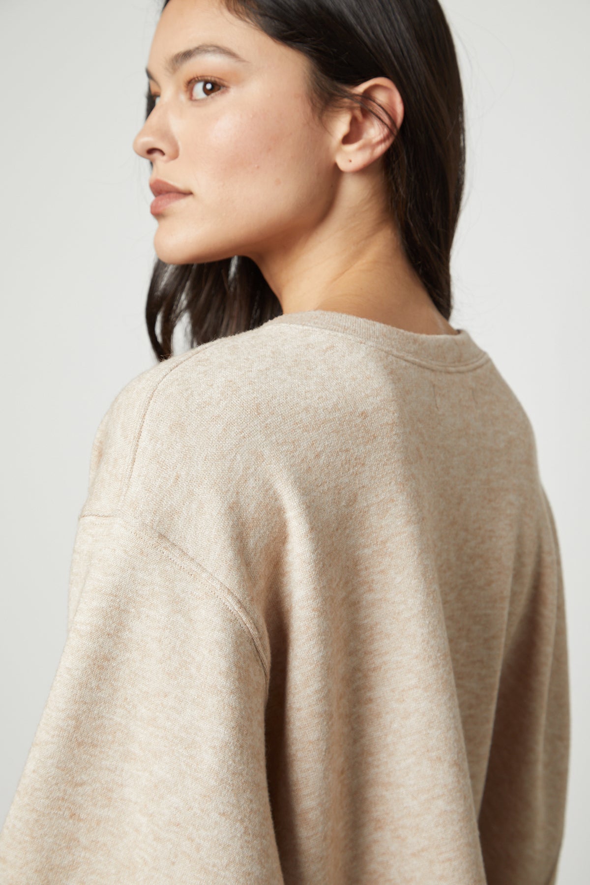   The NIA DOUBLE KNIT CROPPED CREW sweater by Velvet by Graham & Spencer on the woman exudes comfort and style. 