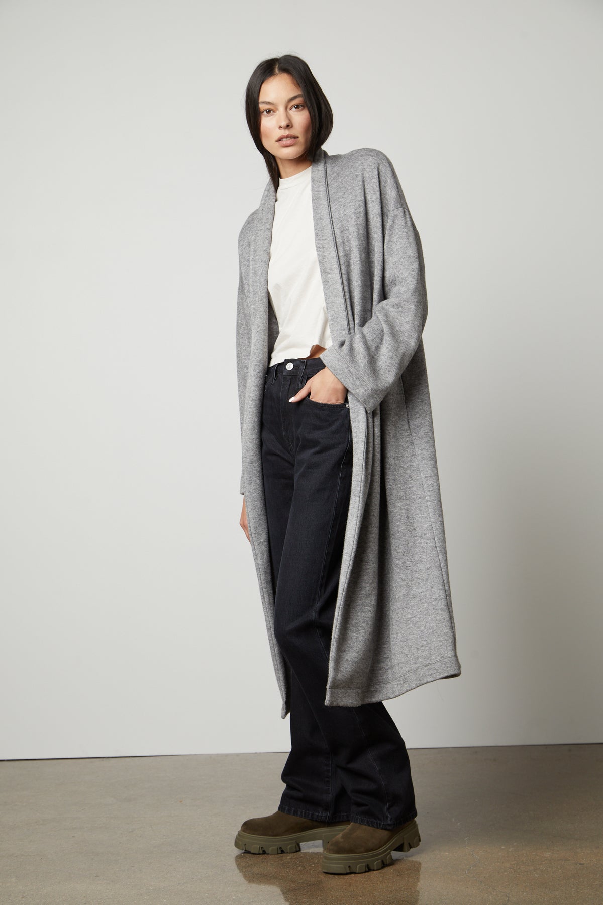   The model is wearing a Velvet by Graham & Spencer PATRICIA DOUBLE KNIT DUSTER CARDIGAN and jeans. 