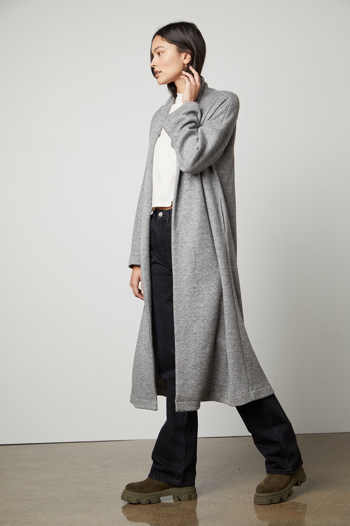 The model is wearing a cozy Velvet by Graham & Spencer Patricia Double Knit Duster Cardigan.-35503544139969
