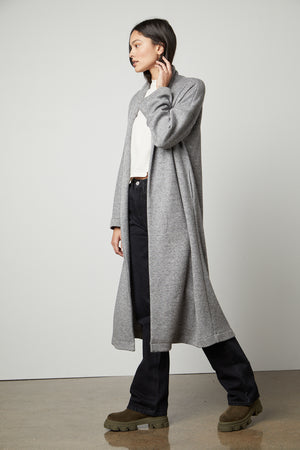 The model is wearing a cozy Velvet by Graham & Spencer Patricia Double Knit Duster Cardigan.