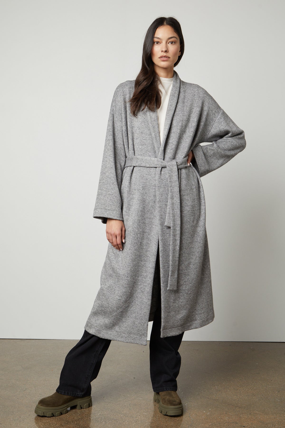 A model wearing a Velvet by Graham & Spencer Patricia Double Knit Duster Cardigan with a belt.-26910331732161