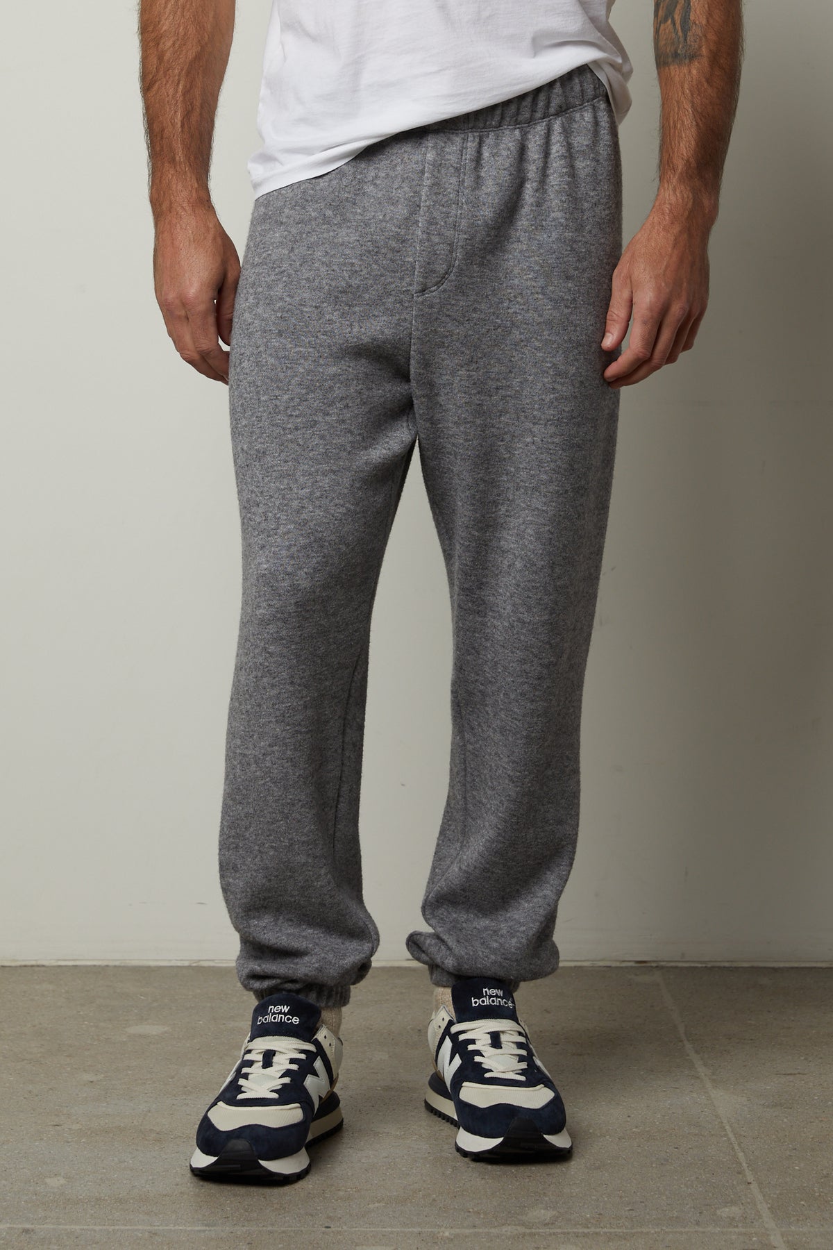   A man wearing Velvet by Graham & Spencer SALINGER DOUBLE KNIT SWEATPANTS, luxurious and comfortable. 
