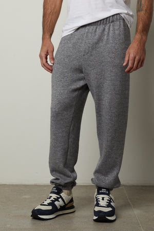 A man wearing the SALINGER DOUBLE KNIT SWEATPANT from Velvet by Graham & Spencer exuding luxurious comfort.