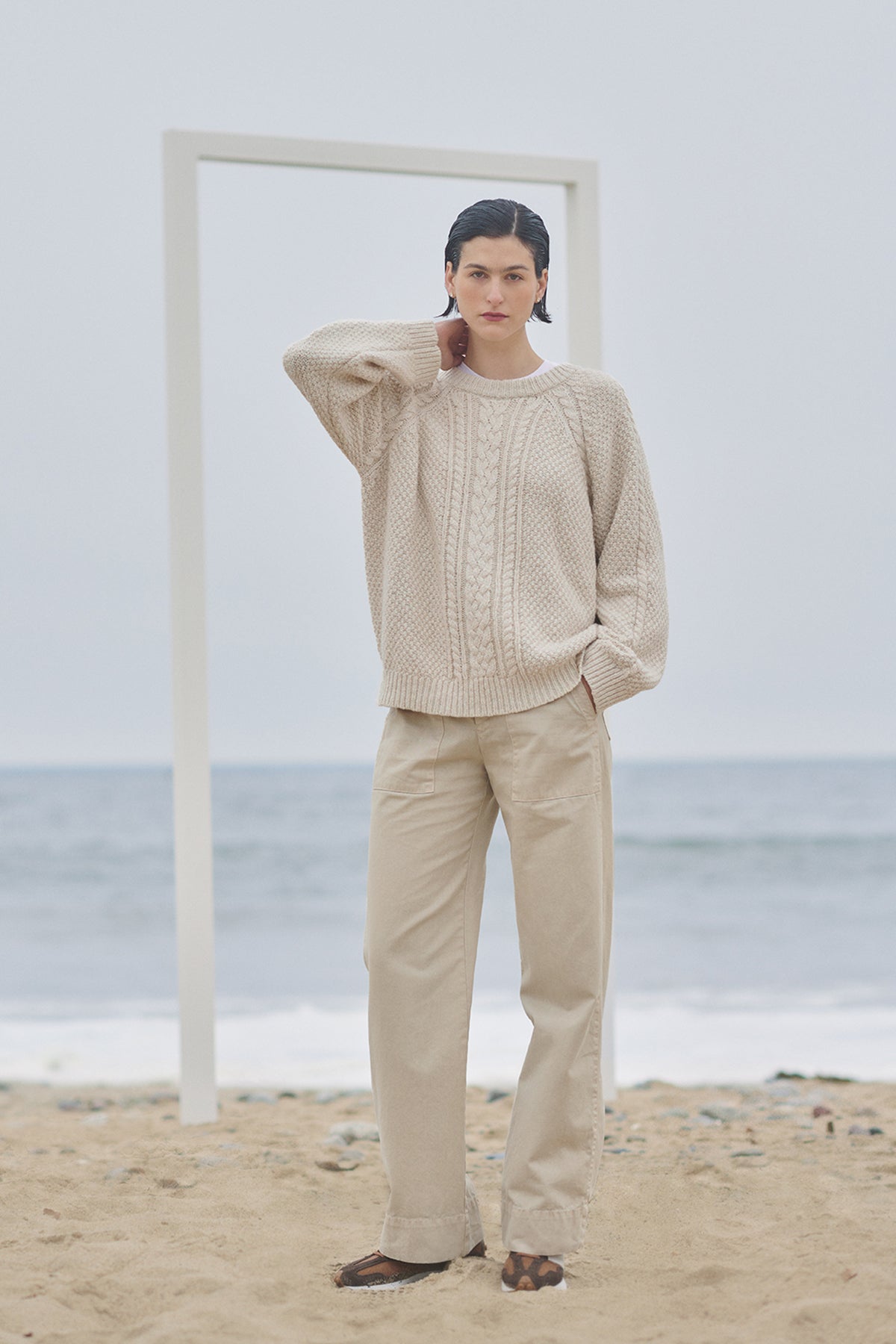 A woman standing on the beach wearing a HERMOSA SWEATER by Velvet by Jenny Graham.-35547792376001