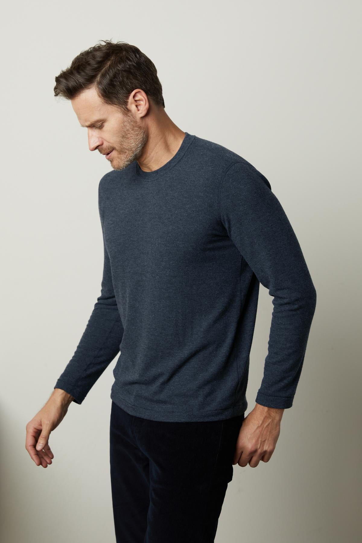 A man in a Velvet by Graham & Spencer BECKER COZY JERSEY CREW sweater and soft black pants.-36320567951553