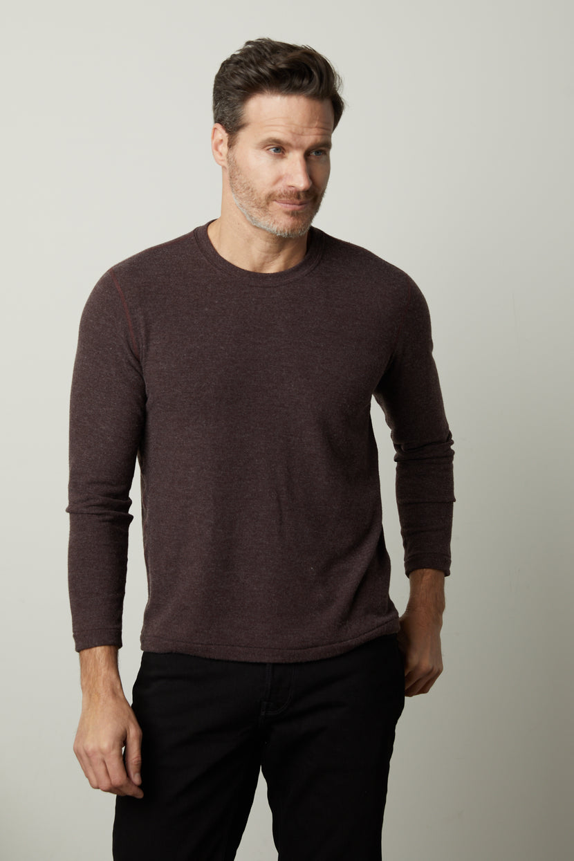 A man wearing a modern comfortable Velvet by Graham & Spencer BECKER COZY JERSEY CREW maroon sweater.