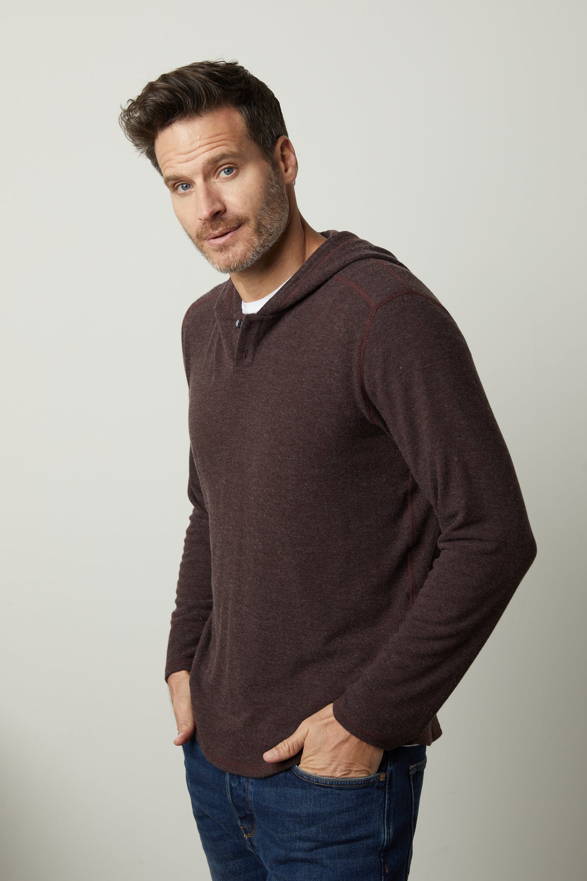 A man wearing a Velvet by Graham & Spencer BYRD COZY JERSEY HOODIE and jeans.-35547521351873