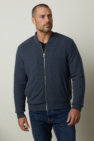 A man wearing a Velvet by Graham & Spencer MILES ZIP-UP JACKET.