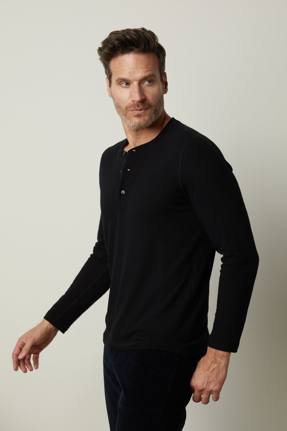   A man wearing a RYLAND HENLEY shirt from Velvet by Graham & Spencer, perfect for casual occasions. 