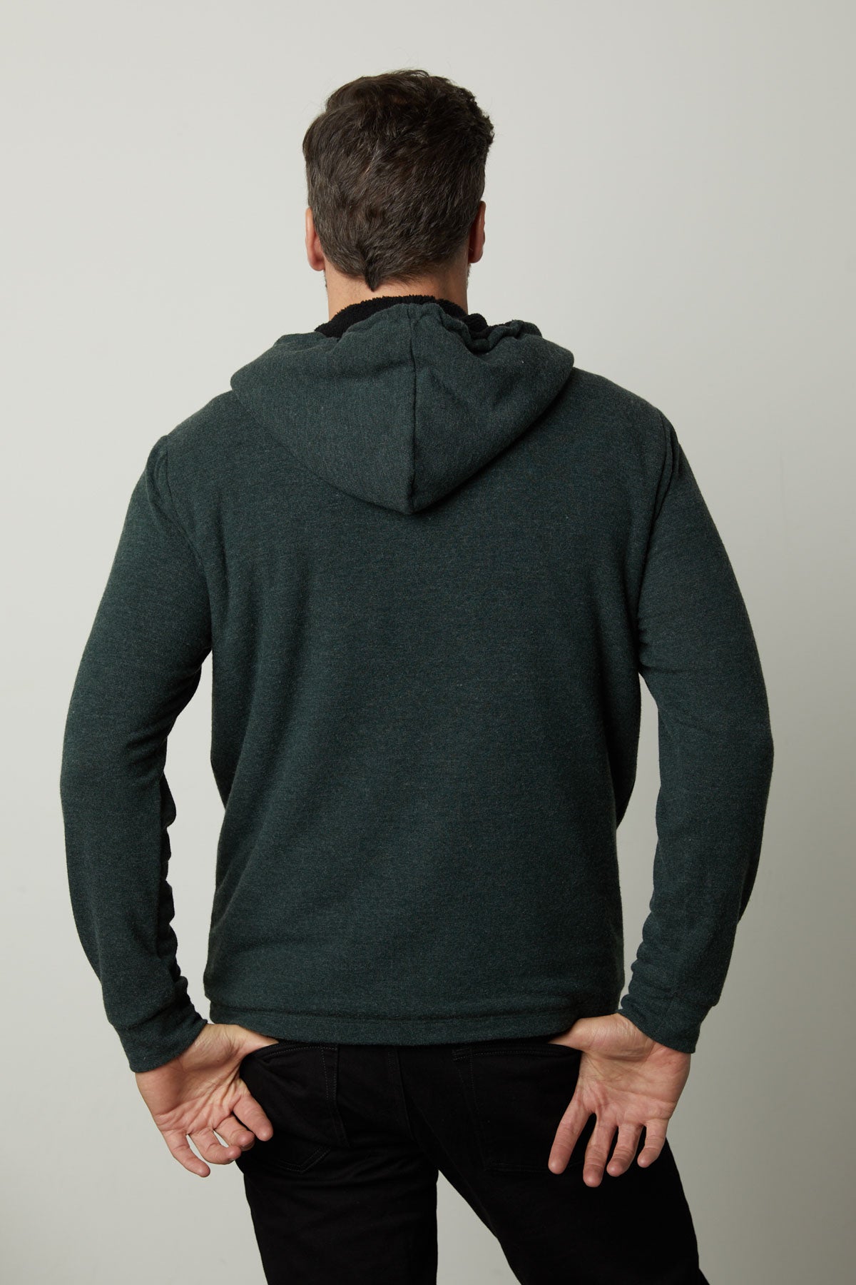 The back view of a man wearing Velvet by Graham & Spencer's SALVADORE SHERPA LINED HOODIE with an adjustable drawstring hood.-35605834137793