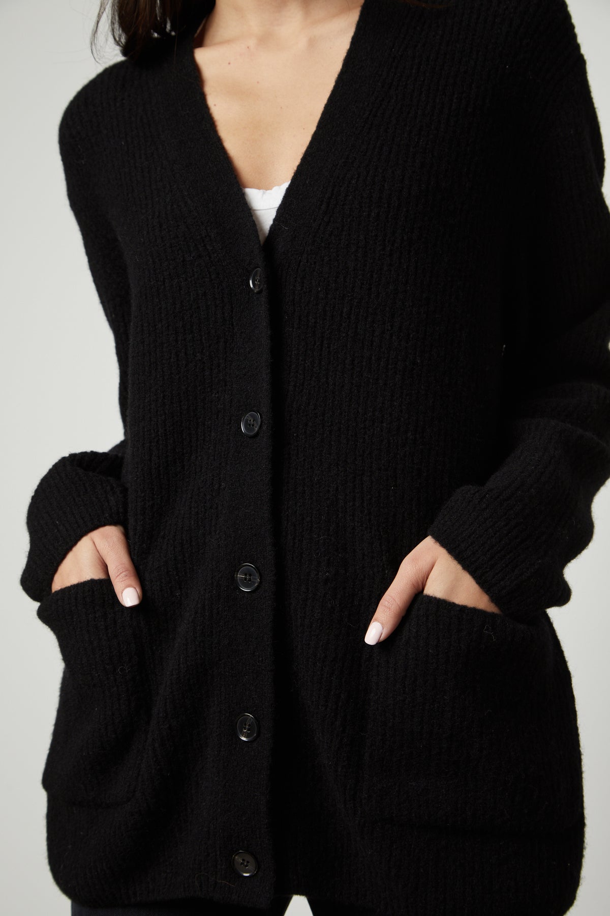 A person wearing Velvet by Graham & Spencer's BRITT OVERSIZED CARDIGAN with pockets.-26897709531329