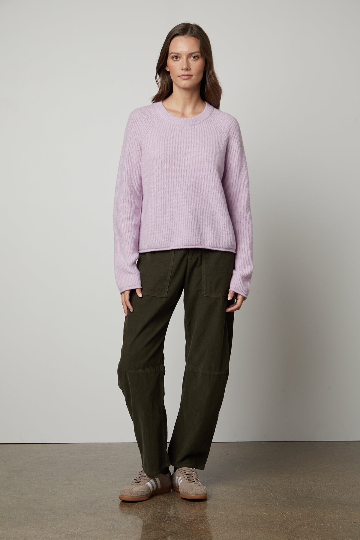   A woman wearing a cozy GIGI CREW NECK SWEATER by Velvet by Graham & Spencer. 