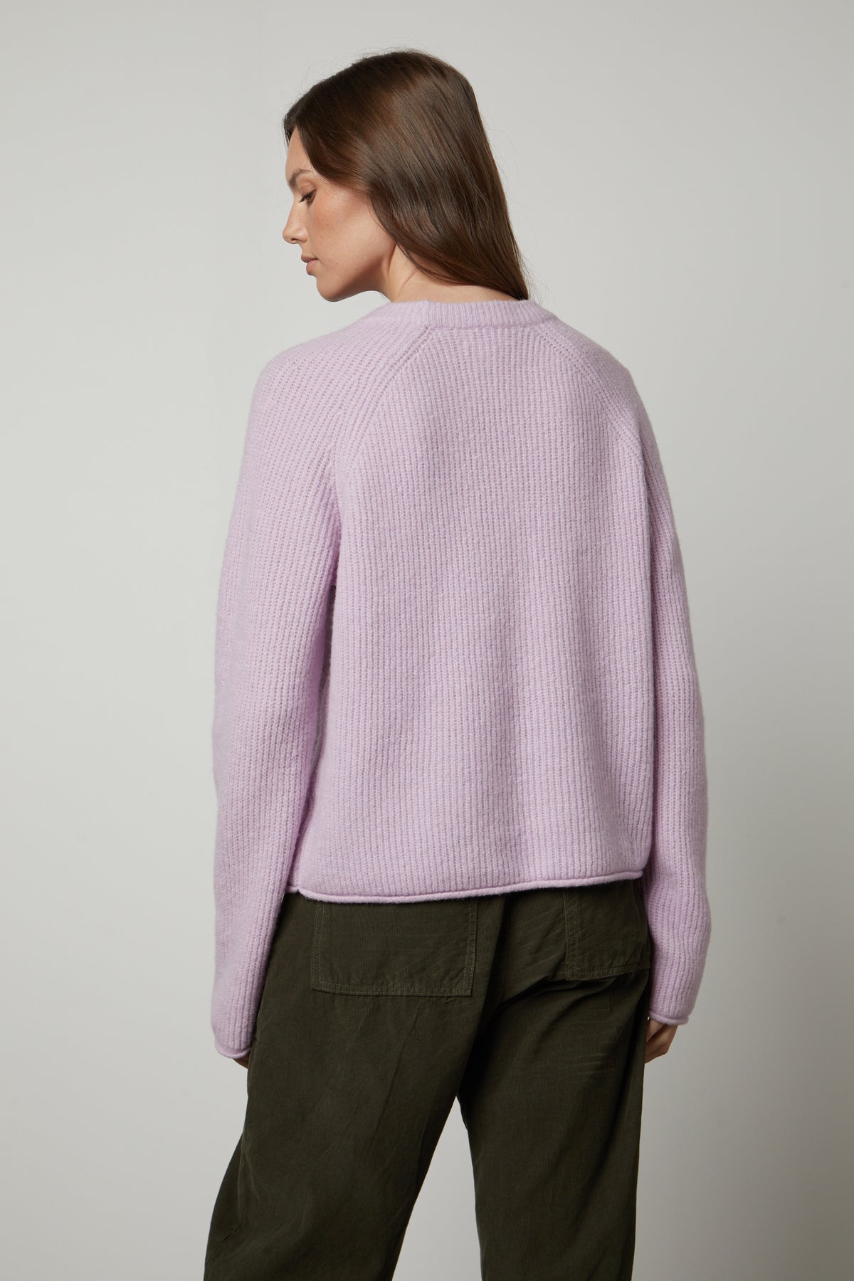   The back view of a woman wearing a Velvet by Graham & Spencer GIGI CREW NECK SWEATER. 