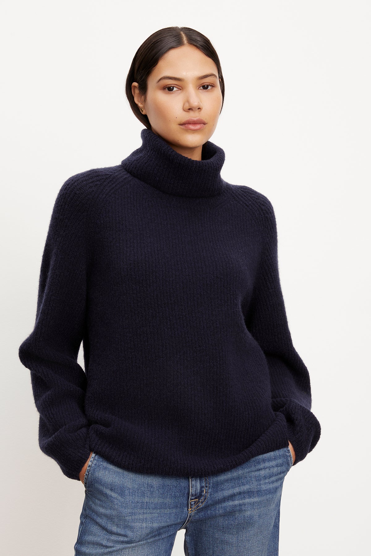 A model wearing a cozy Velvet by Graham & Spencer JUDITH turtleneck sweater.-35577840369857