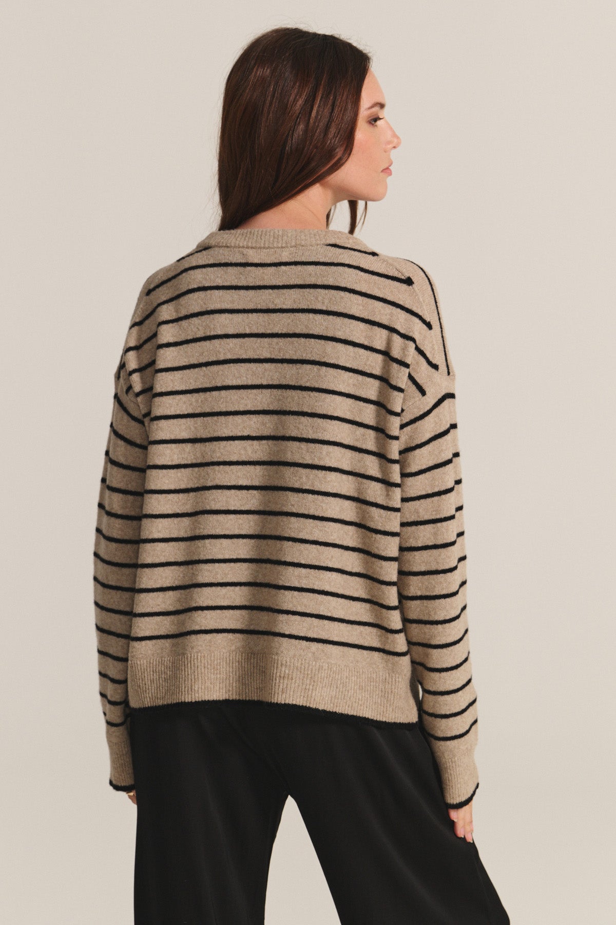 A woman in the ROMY SWEATER by Velvet by Graham & Spencer.-40672489799873