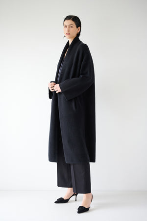 A woman wearing a black Velvet by Jenny Graham CARMEL COAT.