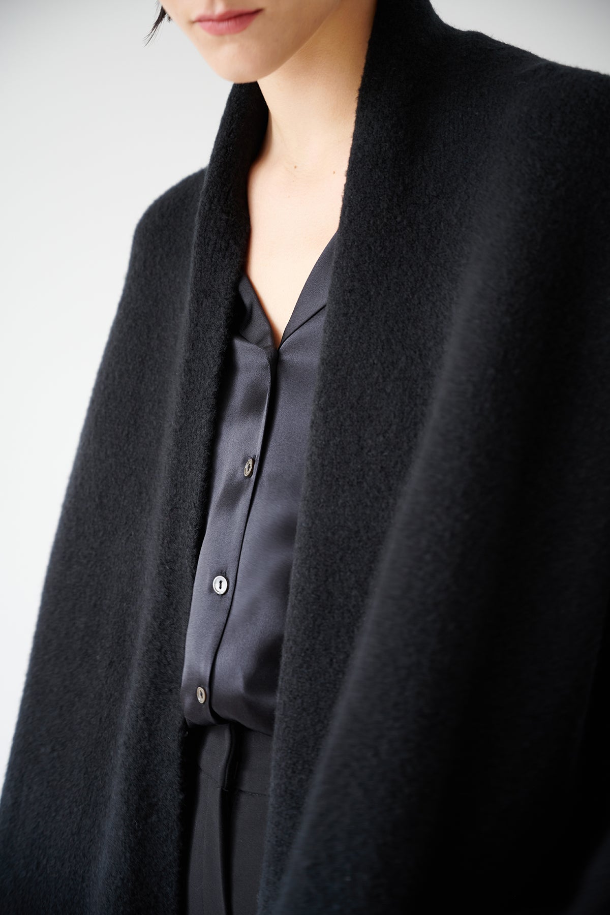 A woman wearing a timeless black coat and a Velvet by Jenny Graham SOHO TOP.-35547449032897