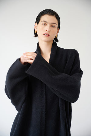 The model is wearing a Velvet by Jenny Graham CARMEL COAT.
