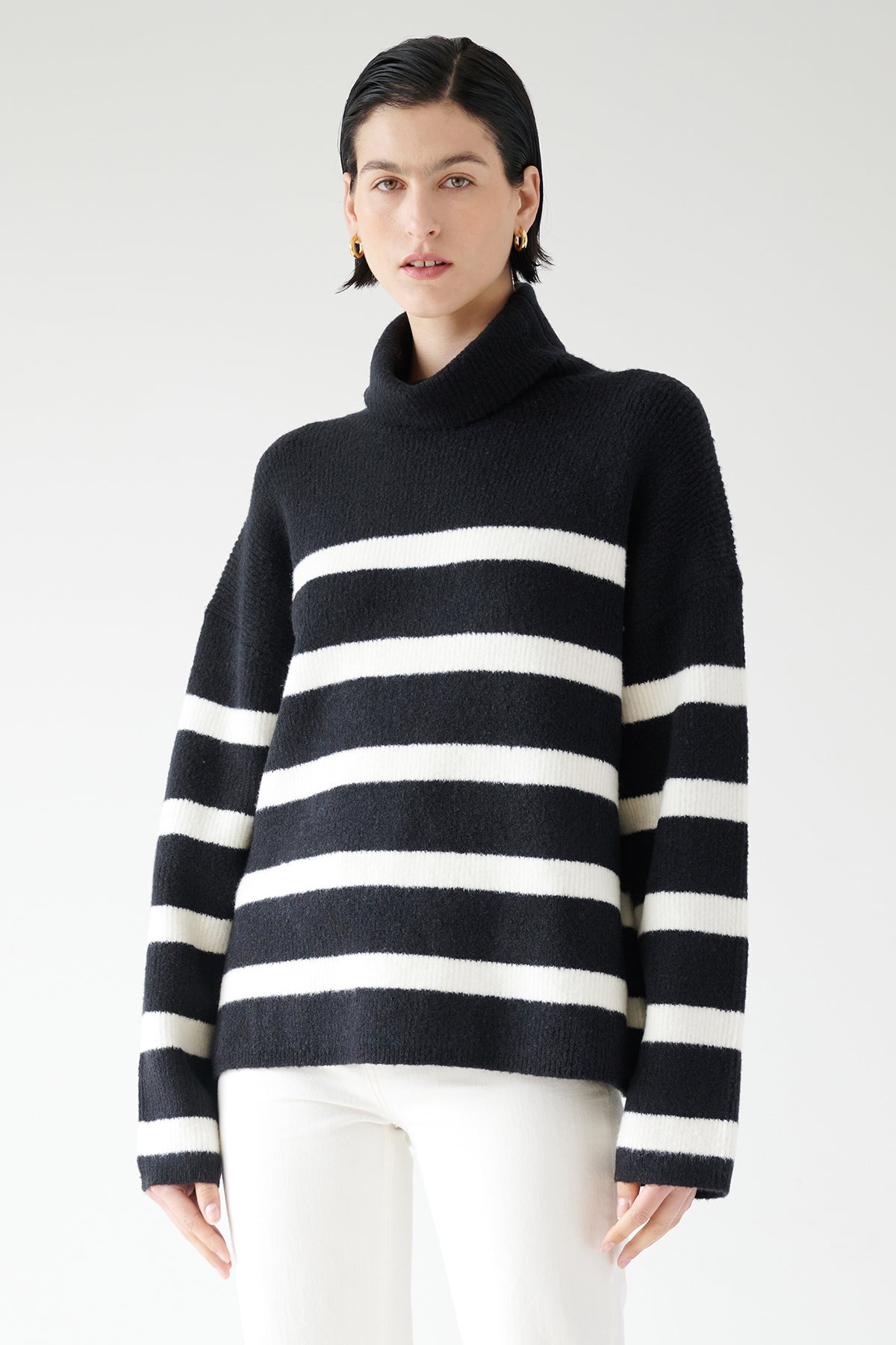   A woman wearing an oversized ENCINO SWEATER by Velvet by Jenny Graham. 