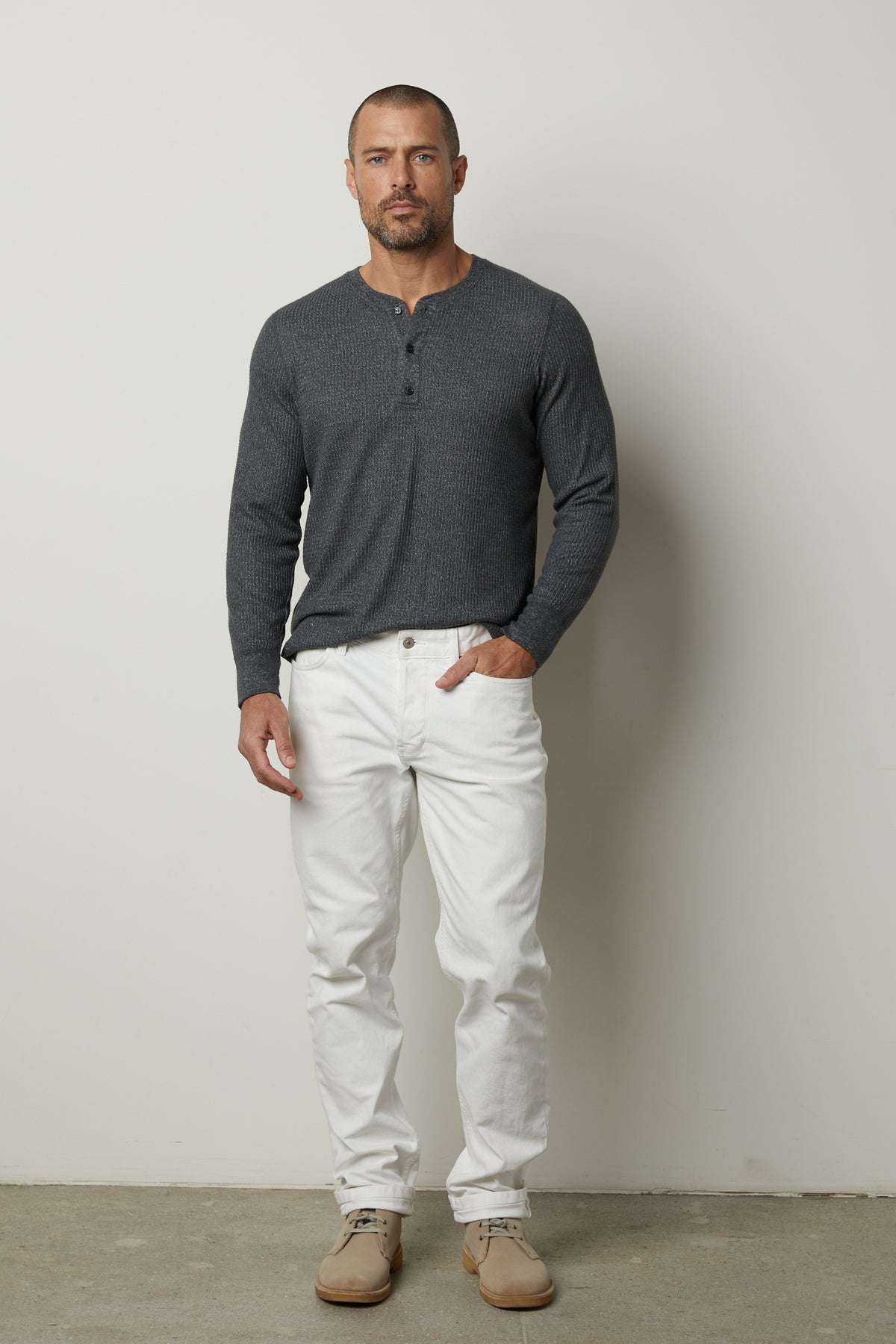A man wearing a grey sweater with an ANTHONY THERMAL HENLEY by Velvet by Graham & Spencer and white pants.-35547473871041