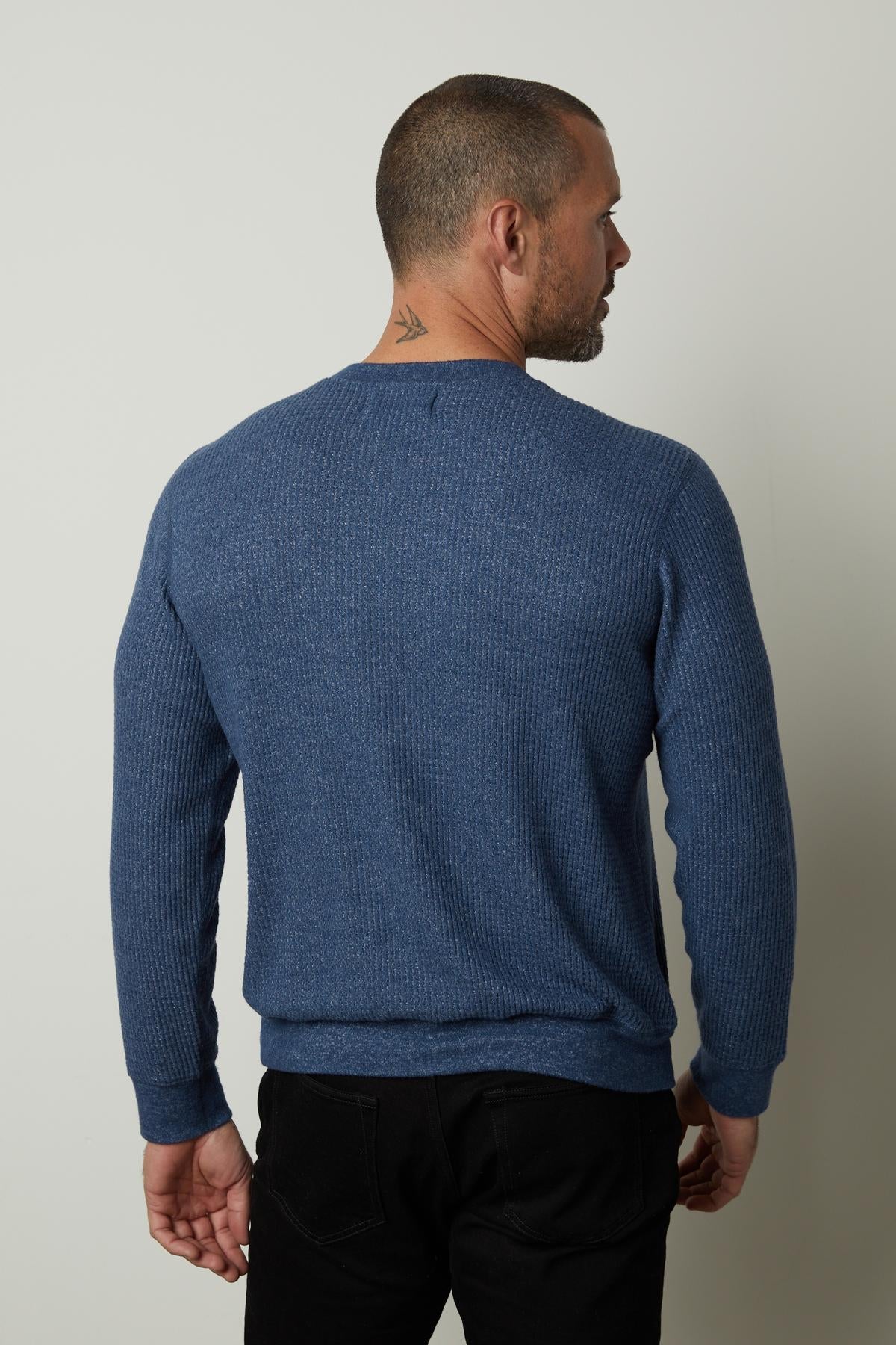The back view of a man wearing a Velvet by Graham & Spencer PONCHO THERMAL CREW blue sweater on cooler days.-35783057178817