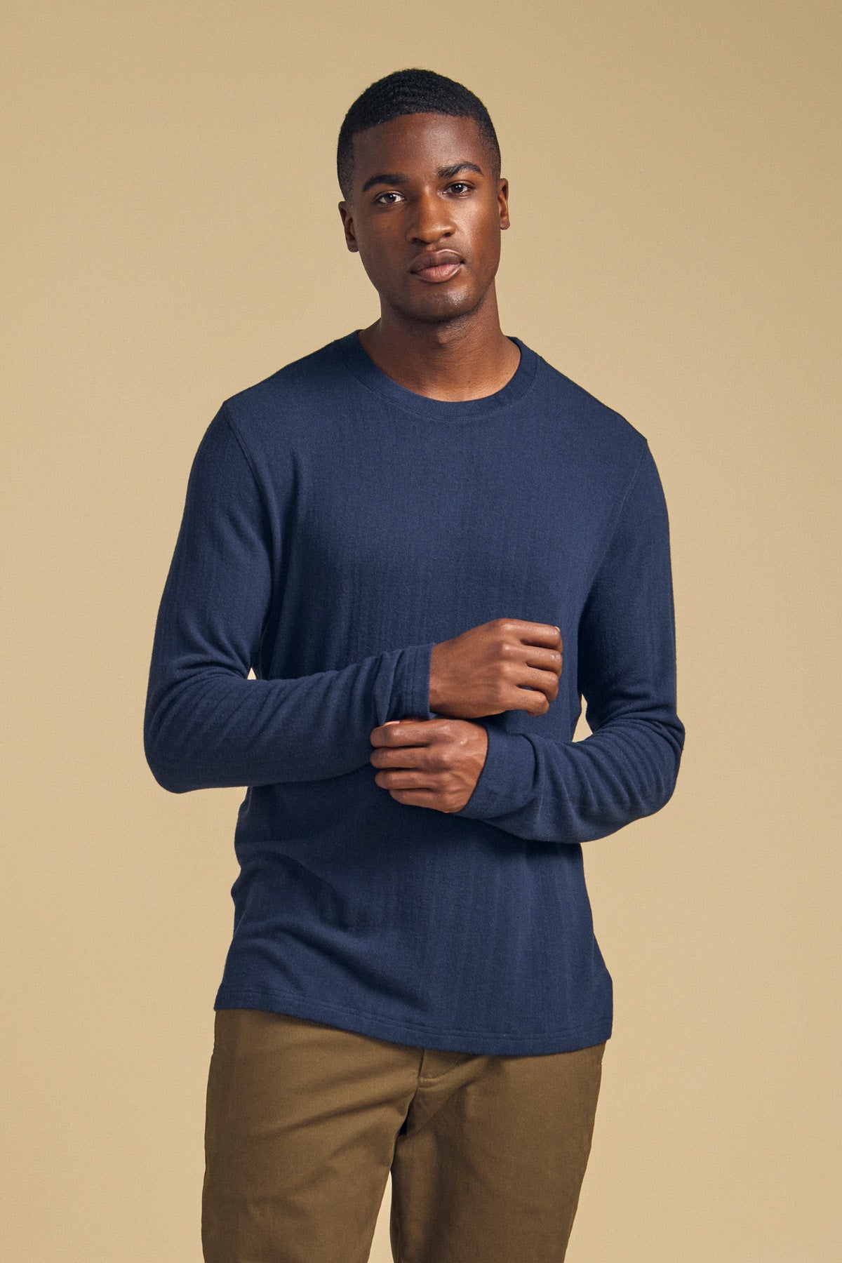 Man wearing a cozy REDDEN CREW PULLOVER, a long-sleeved navy crewneck pullover.-46288510025921