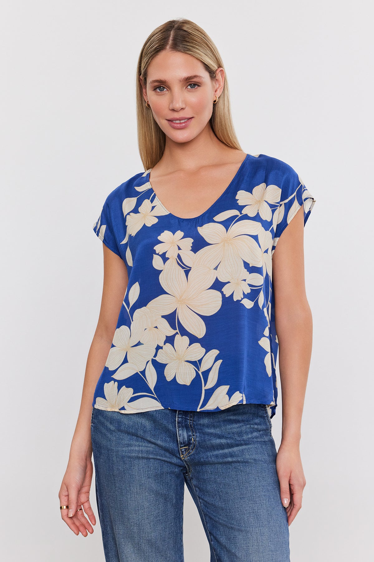   A model wearing a Velvet by Graham & Spencer blue floral print top. 