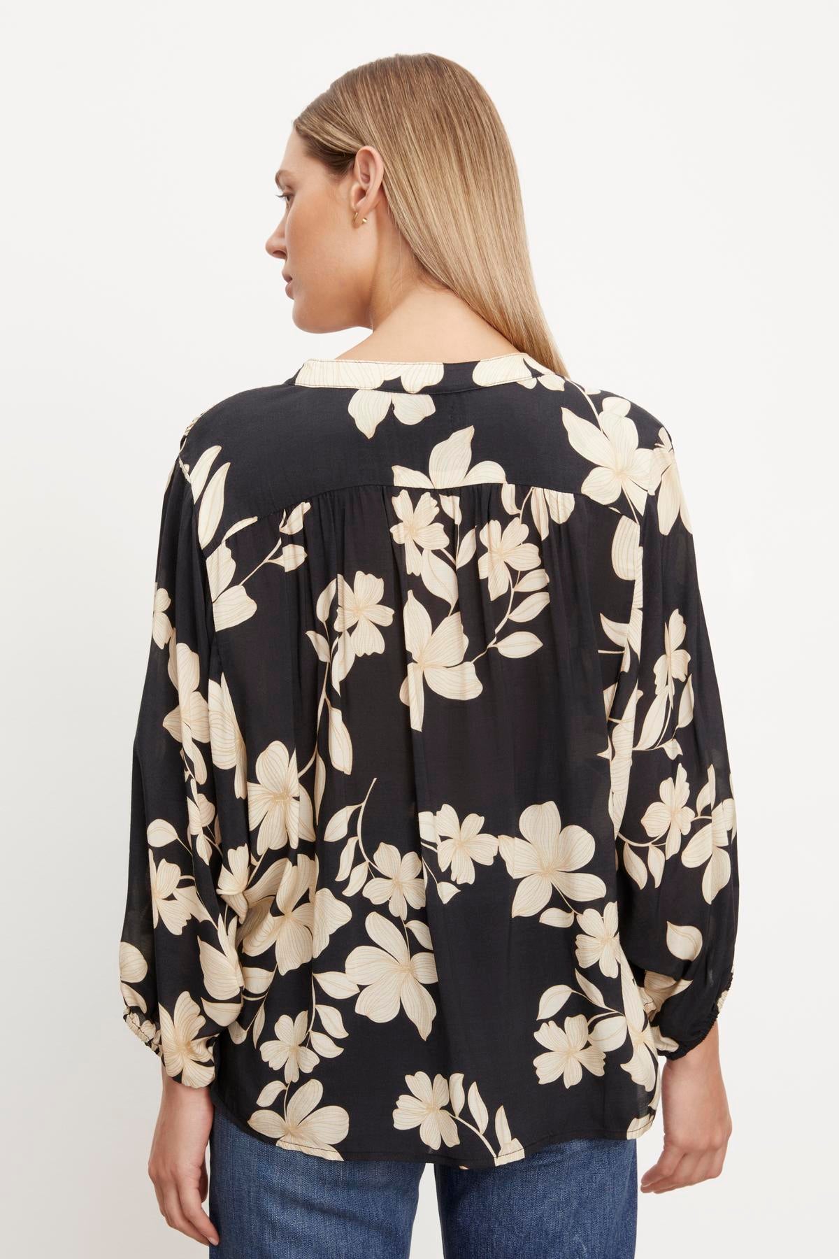   The back view of a woman wearing a Velvet by Graham & Spencer DESTINA PRINTED BUTTON-UP BLOUSE. 