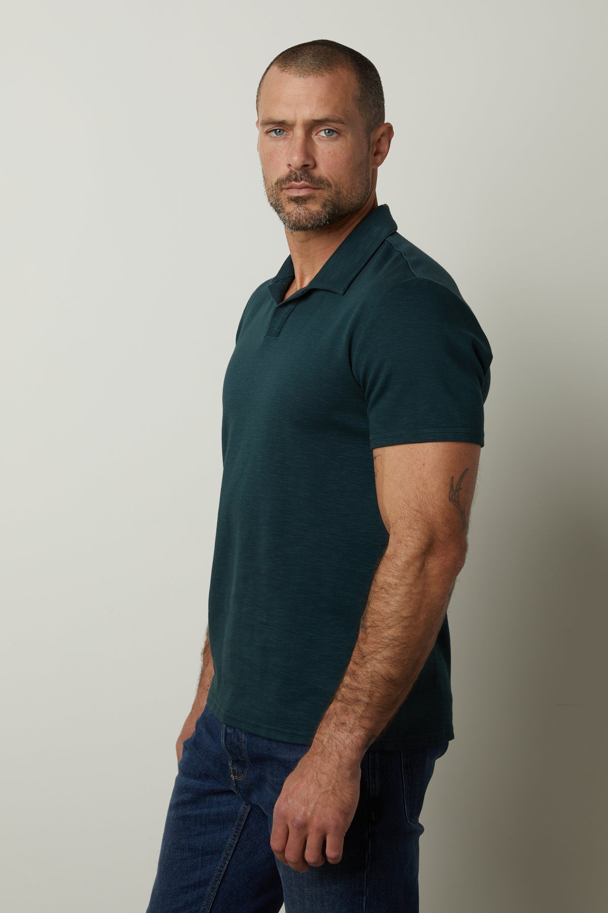 A man wearing jeans and a Velvet by Graham & Spencer DILAN COTTON BLEND POLO shirt.-26846254629057
